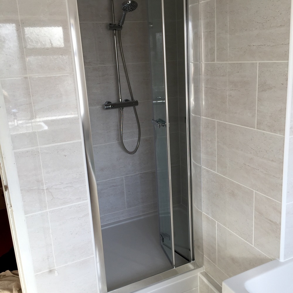 Roman Embrace bi-fold shower door with Adora fusion shower